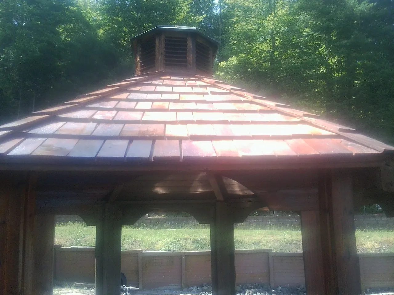 New cedar shake roof and cupola on a lakeside gazebo in Coats